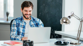 man looking at his laptop