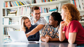 a group of people working on a laptop together