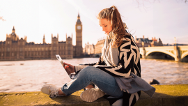 a woman sitting on the embankment in London