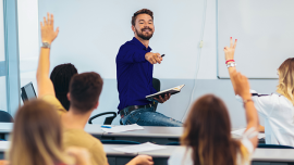 Teacher and students raising their hands during lesson