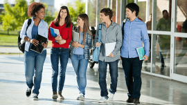 Students smile while walking in a campus
