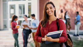 a young woman on campus with other students in the background