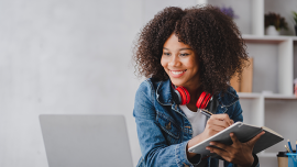Girl takes not a notepad and reads a computer screen