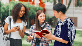 Students talking while looking at books and phones