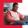 Man smiling getting their IELTS results on their laptop.